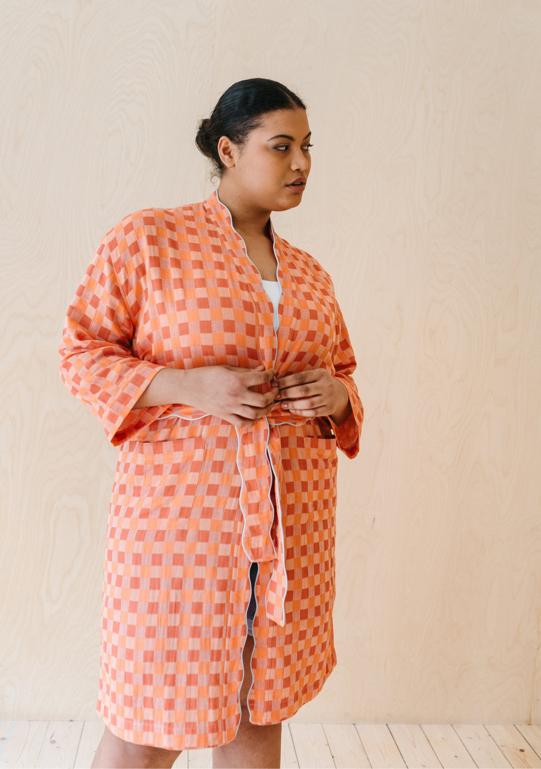 TBCo Cotton Robe in Apricot Checkerboard pattern, featuring scalloped edges and pockets, shown on model against beige backdrop