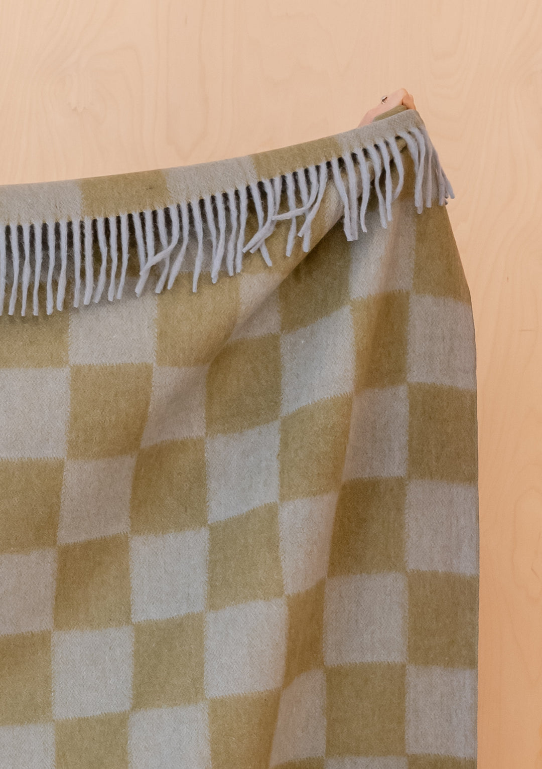 Portrait image gallery position 4 showing fringed TBCo Recycled Wool Blanket in Blue & Green Checkerboard pattern