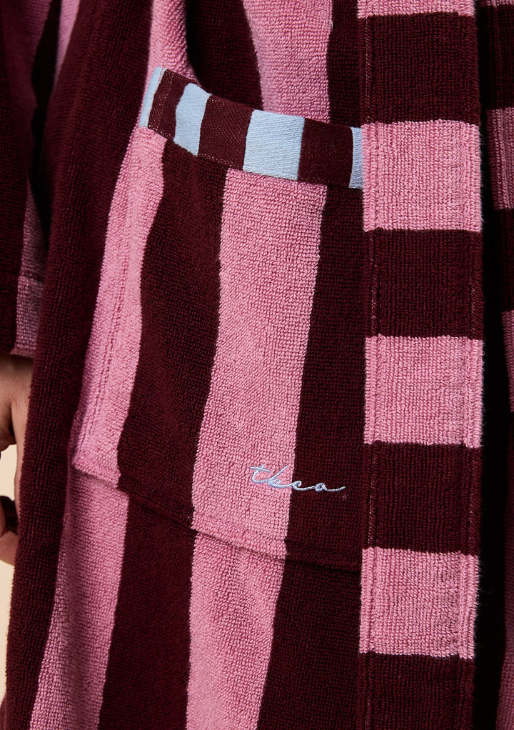 Close-up of TBCo Terry Cotton Bath Robe in Burgundy Stripe showing textured fabric and contrasting stripe pocket detail