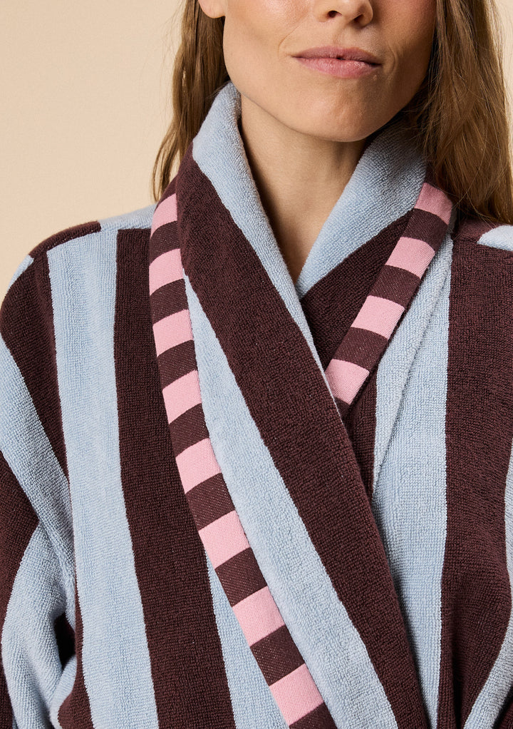 Close-up of TBCo Terry Cotton Bath Robe in Blue Stripe with plush fabric and contrasting pink and brown striped trim design