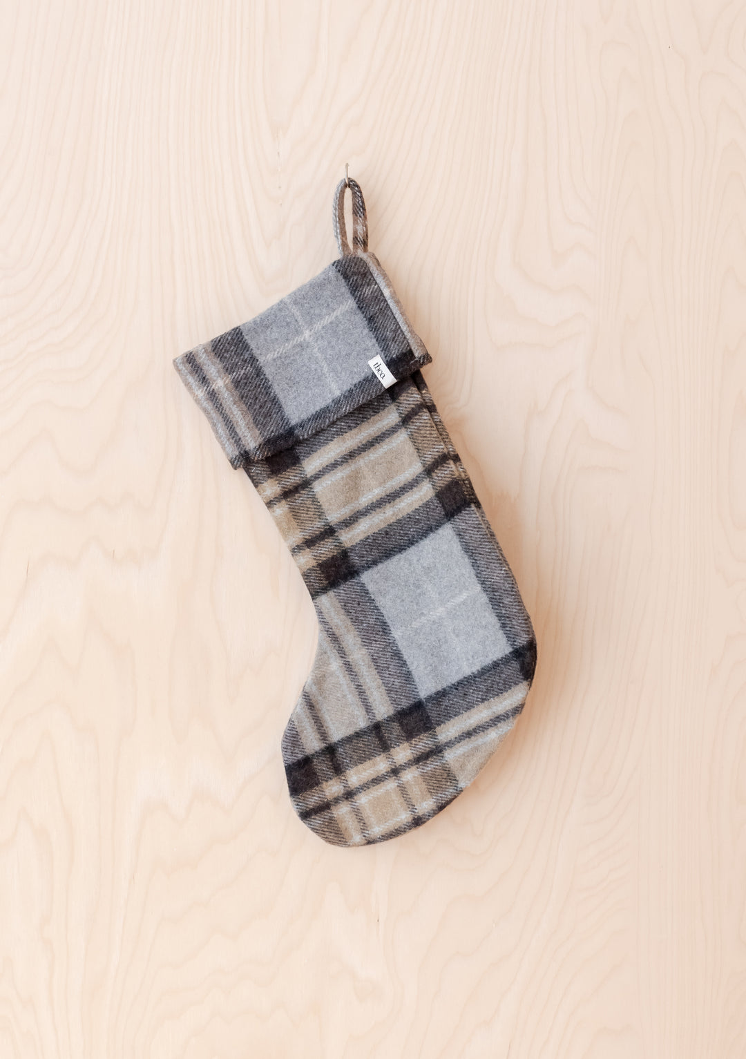 Recycled Wool Christmas Stocking in Mackellar Tartan by TBCo hanging against light wood background