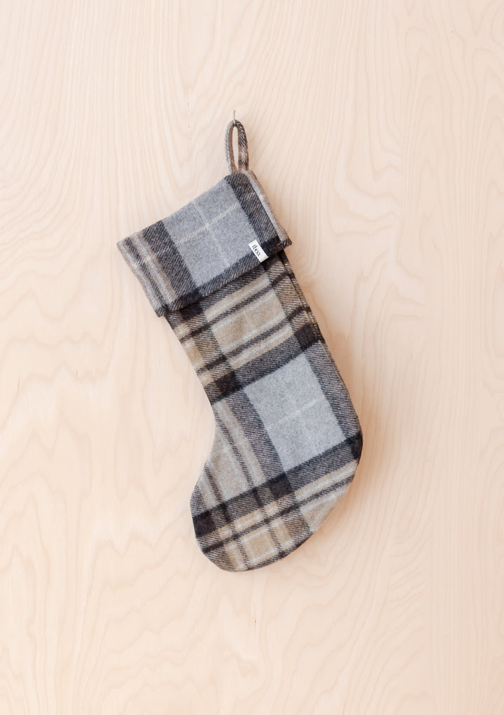 Recycled Wool Christmas Stocking in Mackellar Tartan by TBCo hanging against light wood background