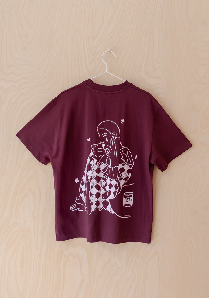 TBCo Cotton T-Shirt in Harlequin, showcasing a harlequin graphic with playing-card symbols on its burgundy back.