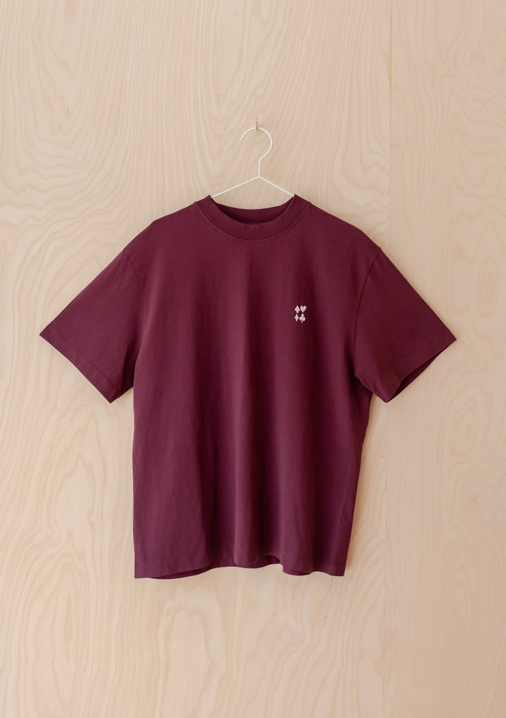 TBCo Cotton T-Shirt in Harlequin, showcasing a harlequin graphic with playing-card symbols on its burgundy on front