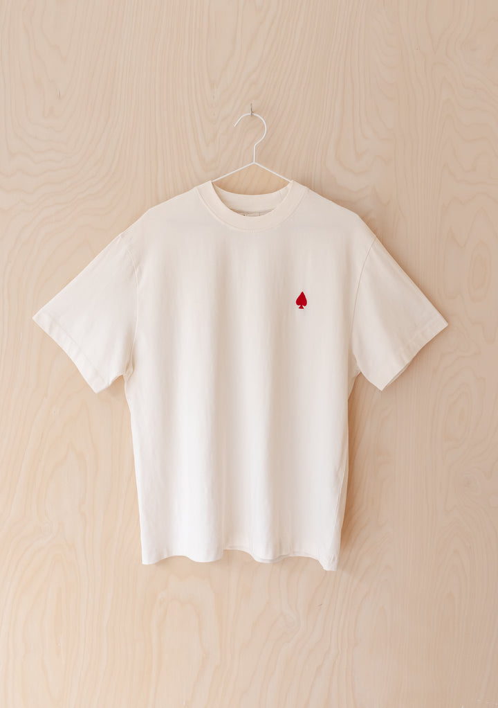 TBCo Cotton T-Shirt in Good Luck Cards, featuring embroidered red spade detail, paired with dark blue jeans.